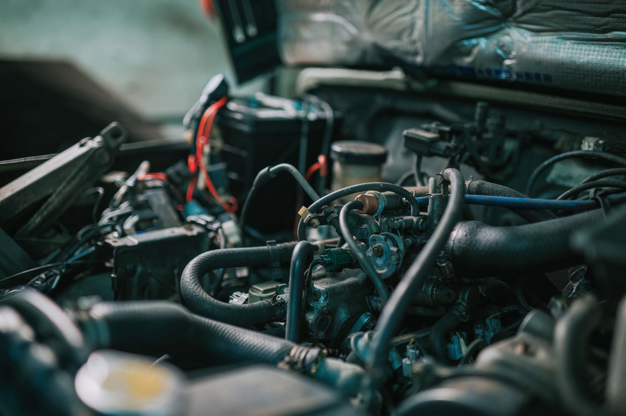 Close-up of a Japanese car engine in a repair bay